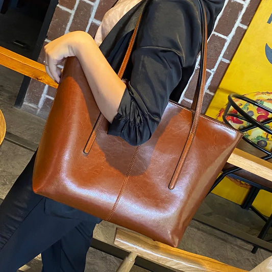 Refined and versatile, this Large-Capacity Cowhide Tote Bag combines high-quality craftsmanship with timeless fashion. Designed for modern women — perfect as a handheld, shoulder, or commuter shopping bag for everyday use
