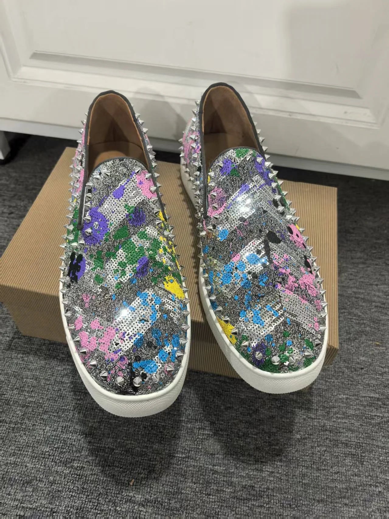 Exclusive to hollandluxeglobal.com, these Men’s Sparkly Sequined Slip-On Sneakers are a true Premium Collector’s Item. Featuring a glittering sequined upper, rivet-studded details, and a comfortable slip-on fit
