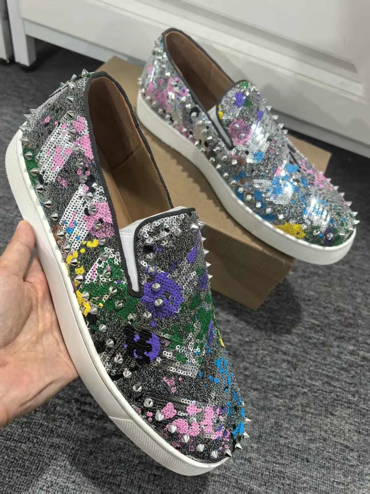 Exclusive to hollandluxeglobal.com, these Men’s Sparkly Sequined Slip-On Sneakers are a true Premium Collector’s Item. Featuring a glittering sequined upper, rivet-studded details, and a comfortable slip-on fit