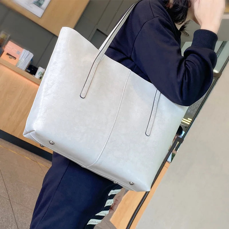 Refined and versatile, this Large-Capacity Cowhide Tote Bag combines high-quality craftsmanship with timeless fashion. Designed for modern women — perfect as a handheld, shoulder, or commuter shopping bag for everyday use
