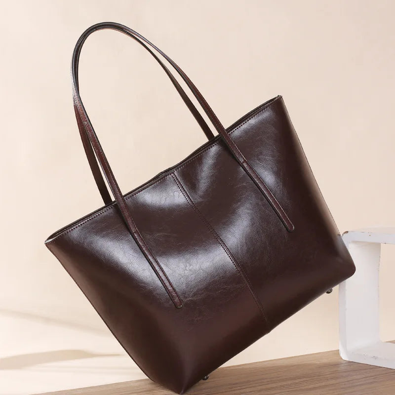 Refined and versatile, this Large-Capacity Cowhide Tote Bag combines high-quality craftsmanship with timeless fashion. Designed for modern women — perfect as a handheld, shoulder, or commuter shopping bag for everyday use