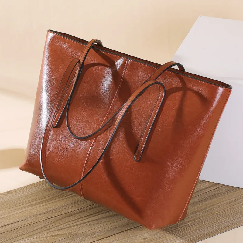 Refined and versatile, this Large-Capacity Cowhide Tote Bag combines high-quality craftsmanship with timeless fashion. Designed for modern women — perfect as a handheld, shoulder, or commuter shopping bag for everyday use