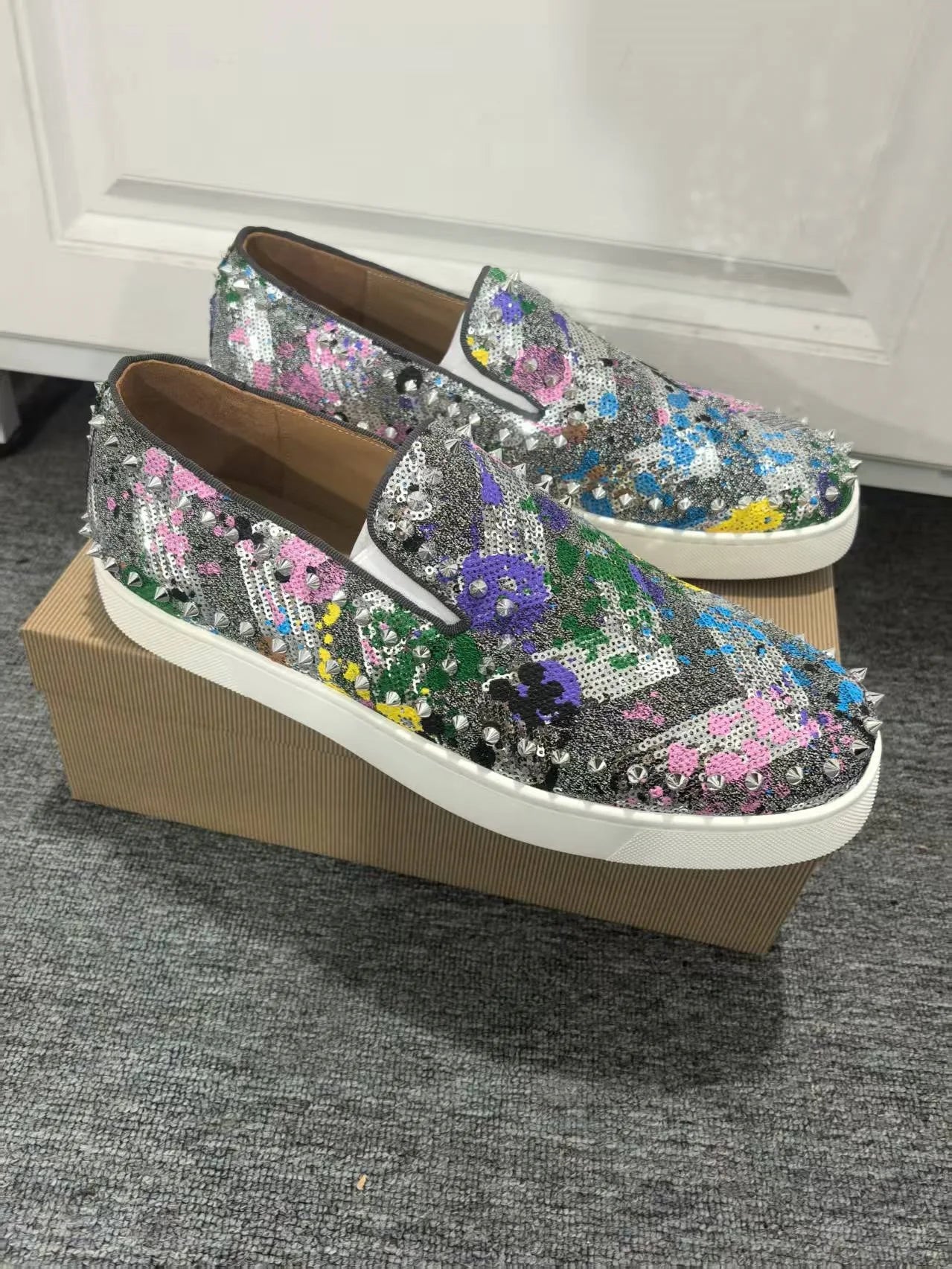 Exclusive to hollandluxeglobal.com, these Men’s Sparkly Sequined Slip-On Sneakers are a true Premium Collector’s Item. Featuring a glittering sequined upper, rivet-studded details, and a comfortable slip-on fit