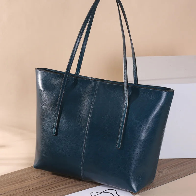 Refined and versatile, this Large-Capacity Cowhide Tote Bag combines high-quality craftsmanship with timeless fashion. Designed for modern women — perfect as a handheld, shoulder, or commuter shopping bag for everyday use