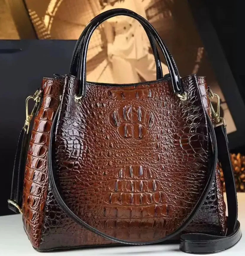 Introducing the Valeria Croco Bucket Tote, a statement piece from the Holland Luxe Global Collectors’ Collection. Designed with a crocodile-embossed finish and a retro-inspired silhouette